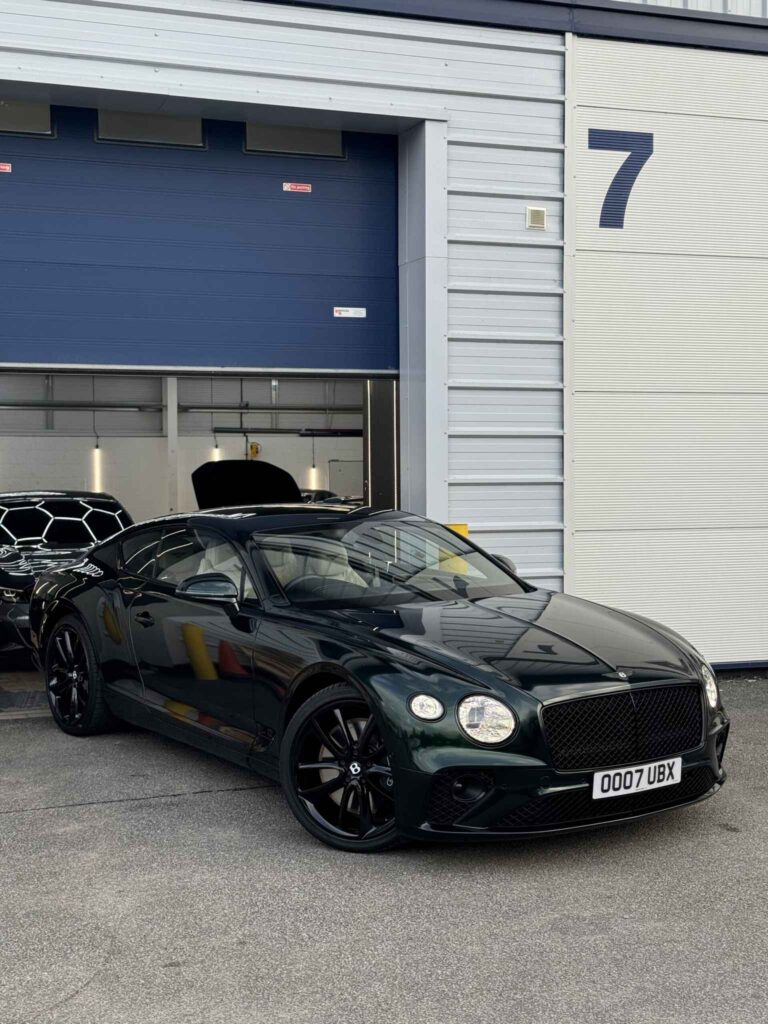 Dark green Bentley Continental outside Unit 7