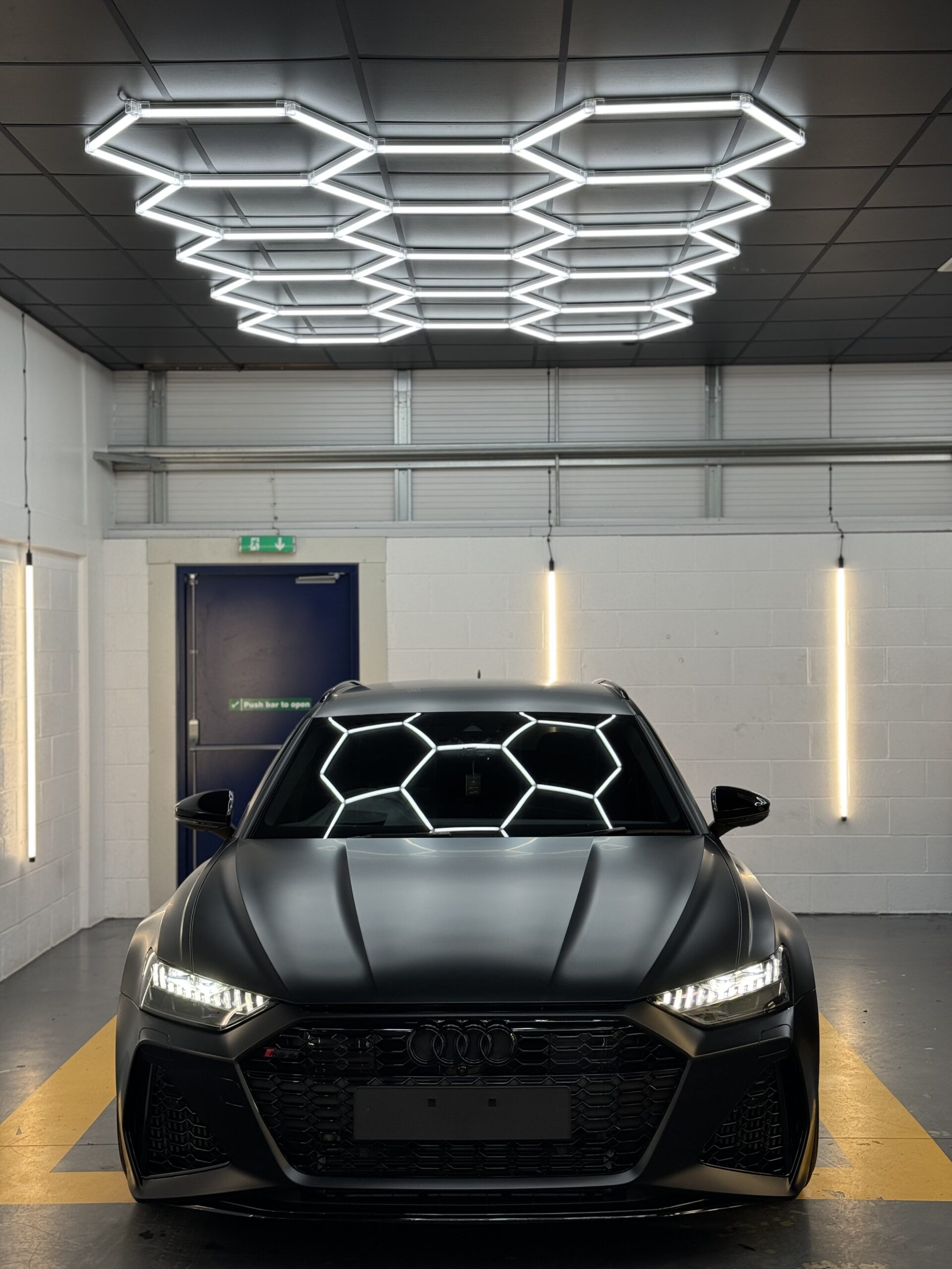 Black Audi RS6 under the hexagon lights