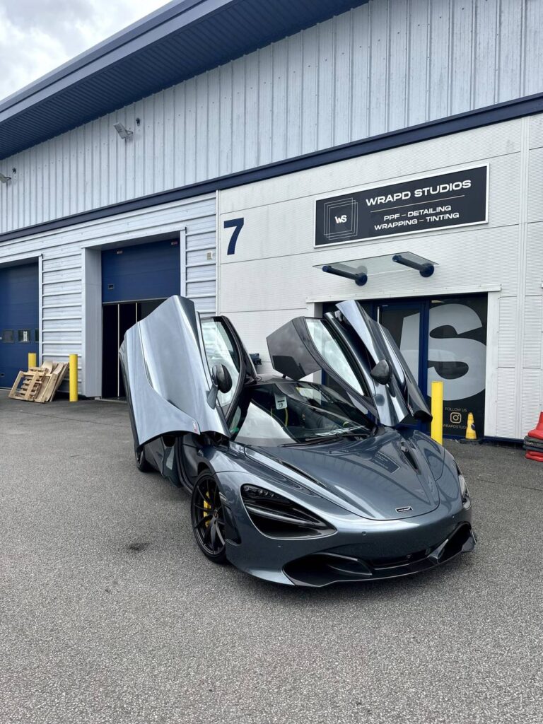 Grey McLaren with doors open outside Wrapd Studios