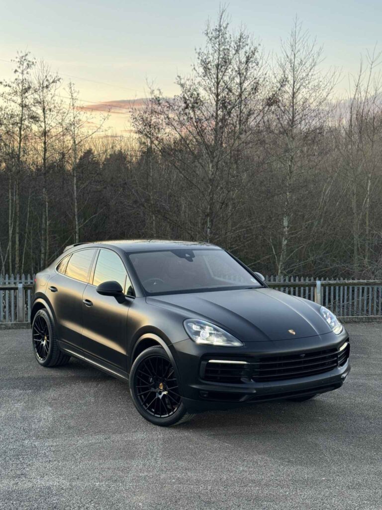 Matte black Porsche Cayenne parked outdoors