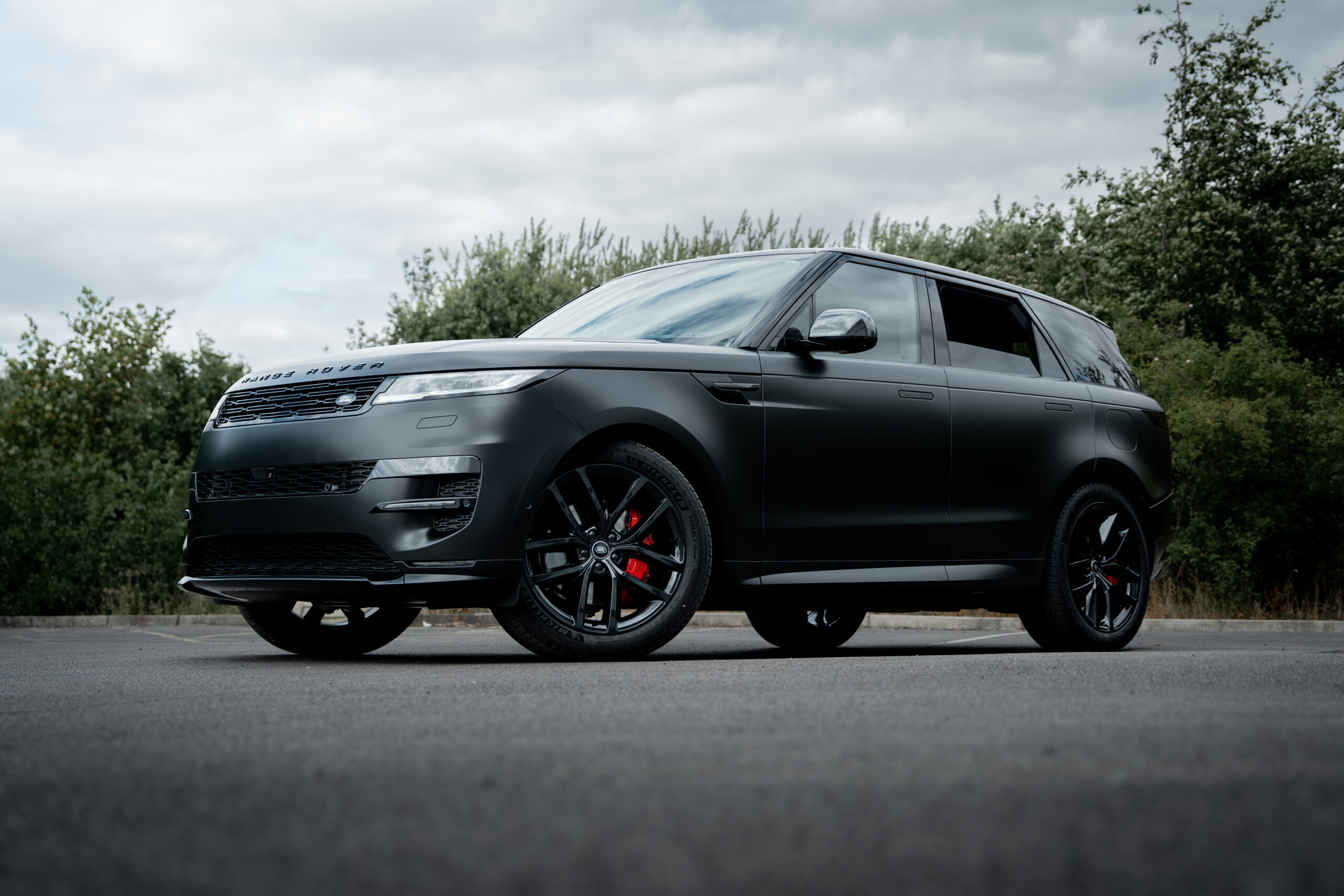 Satin black Range Rover Sport, front three-quarter view