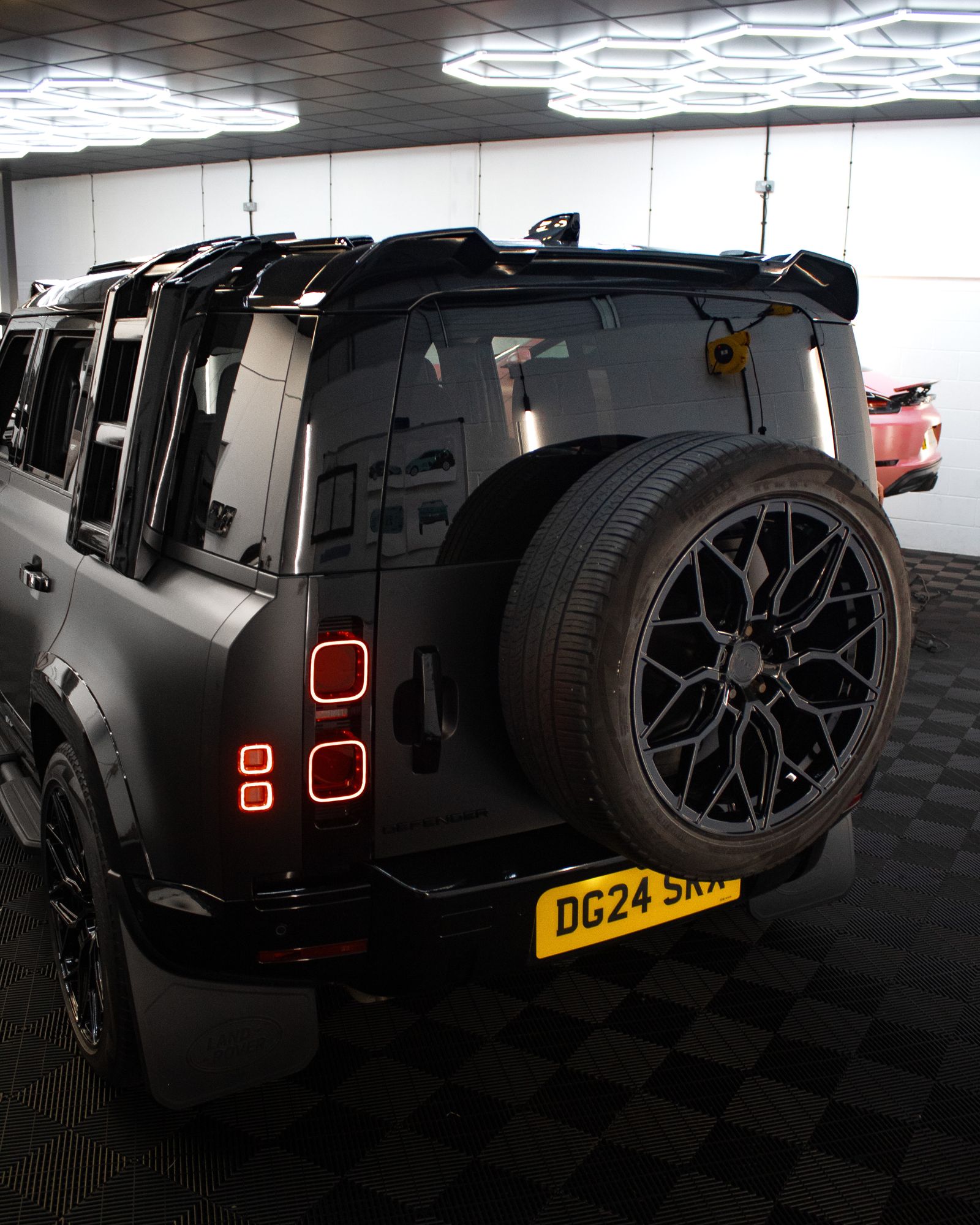 Satin black Land Rover Defender 110, rear view