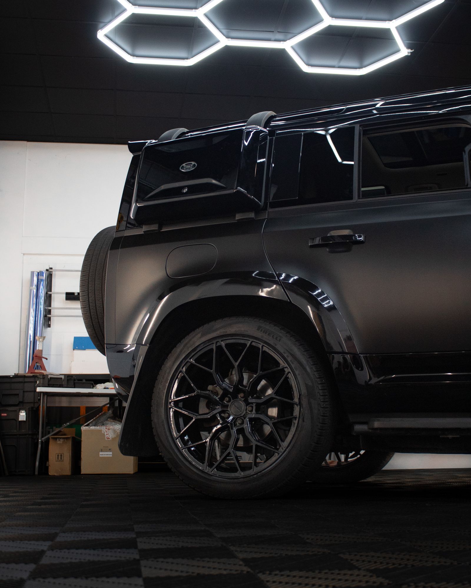 Satin black Land Rover Defender 110, side view