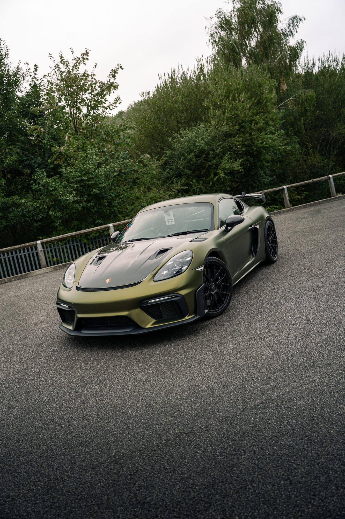Satin green Porsche 718 Cayman GT4 RS outdoors