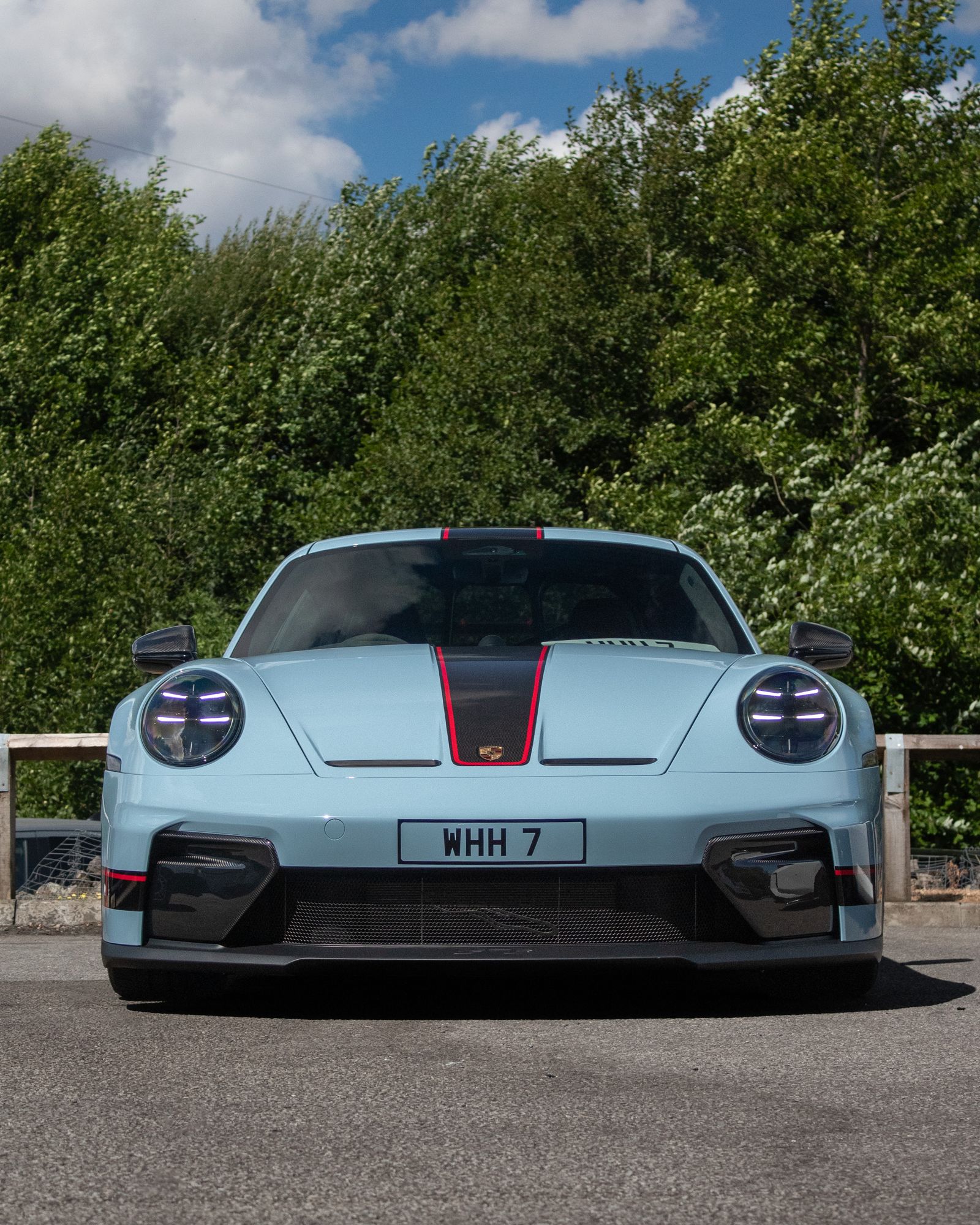 Light blue Porsche 911 GT3 with red accents, front view