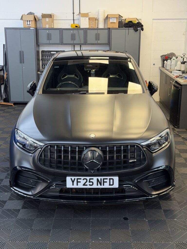 Satin grey Mercedes-AMG SUV, front view, in the Wrapd Studios workshop