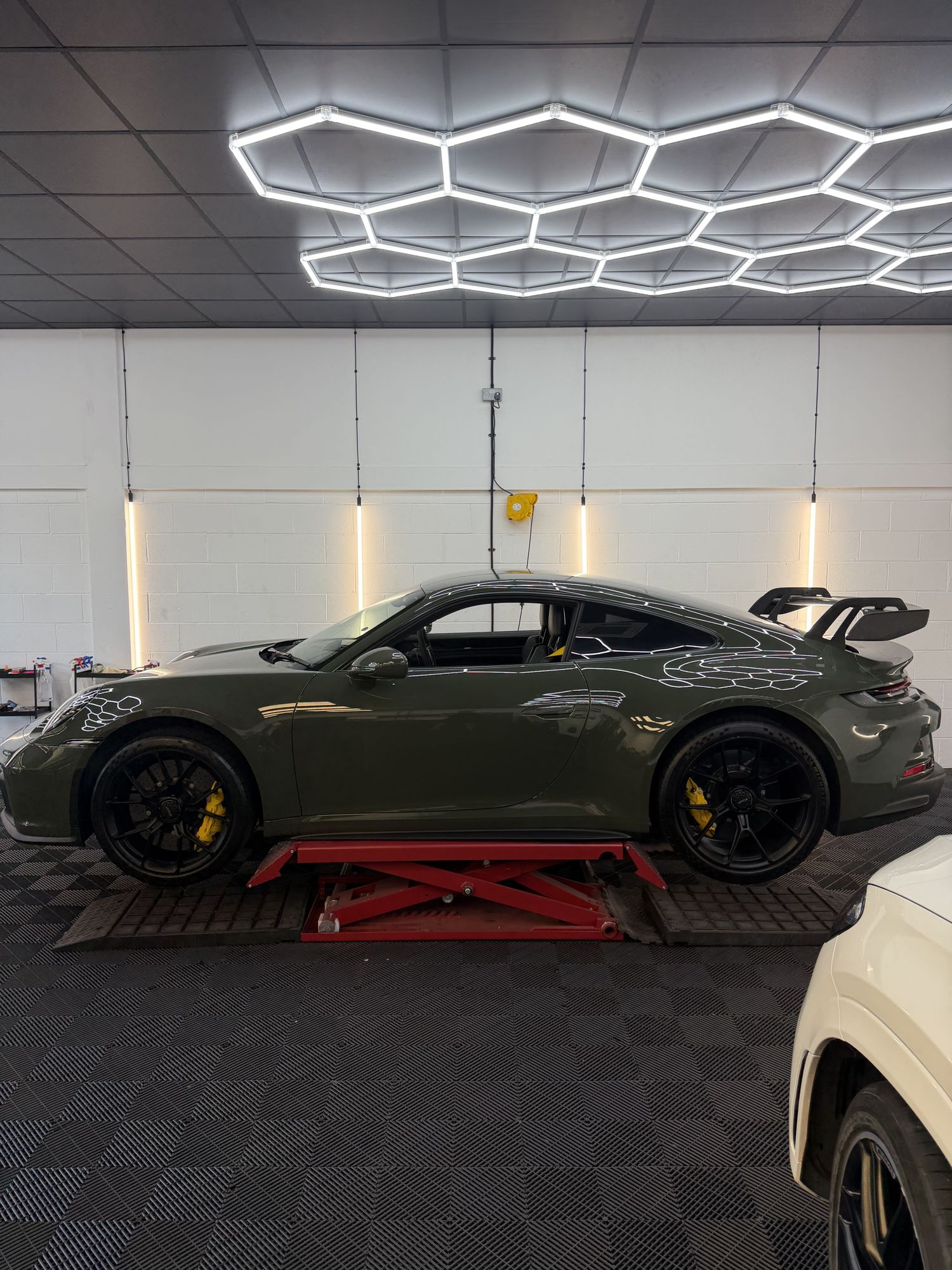 Green Porsche 911 in the studio, side view