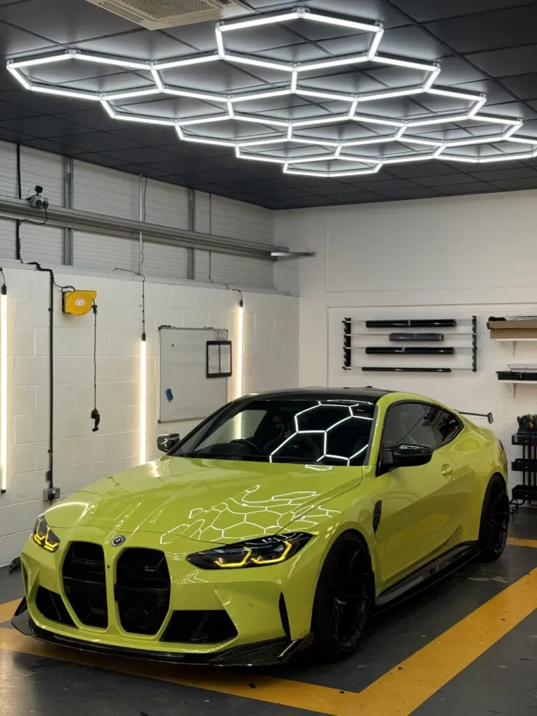 Lime green BMW M4 in the Wrapd Studios bay