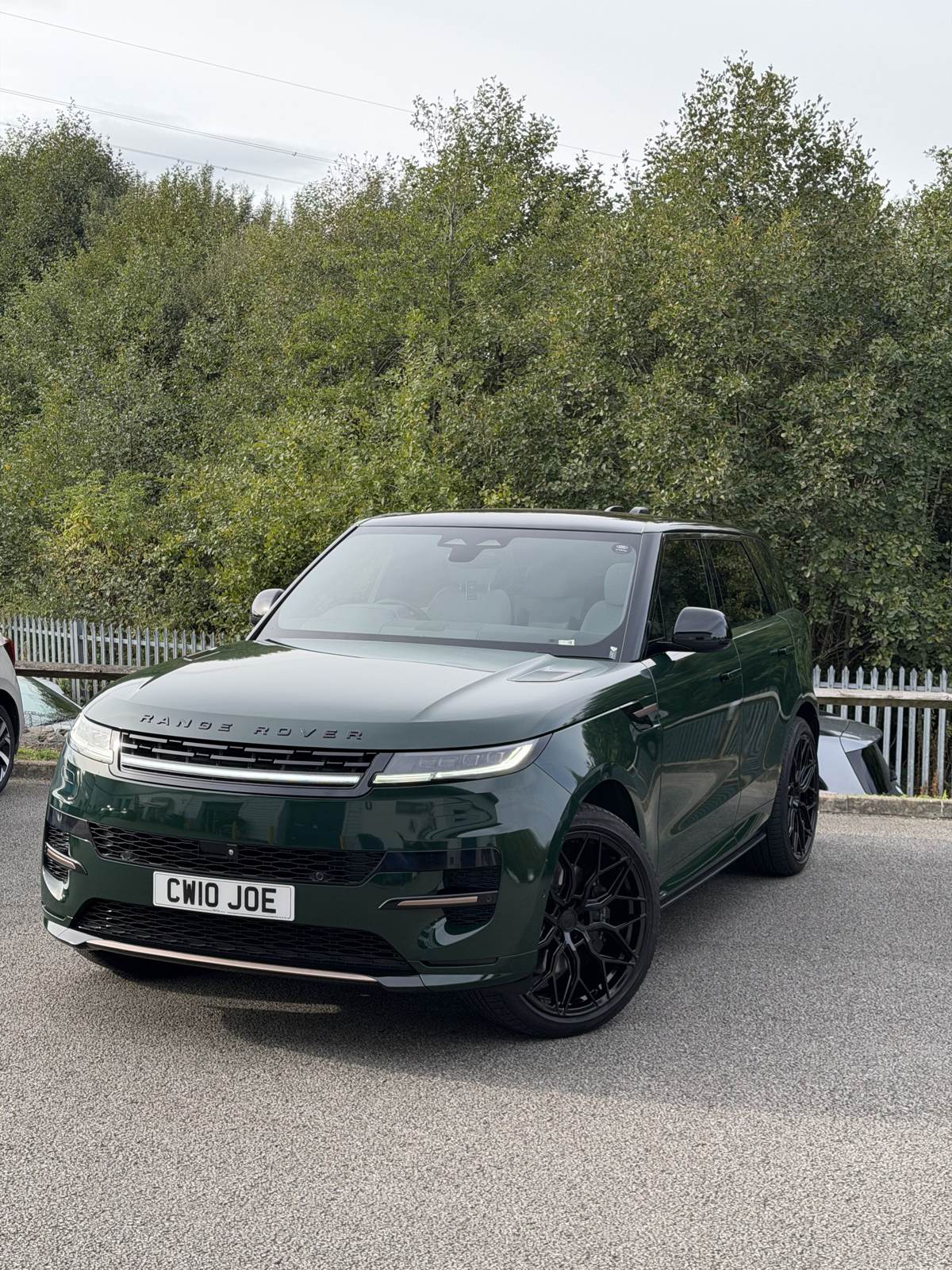 Dark green Range Rover Sport with black trim outdoors
