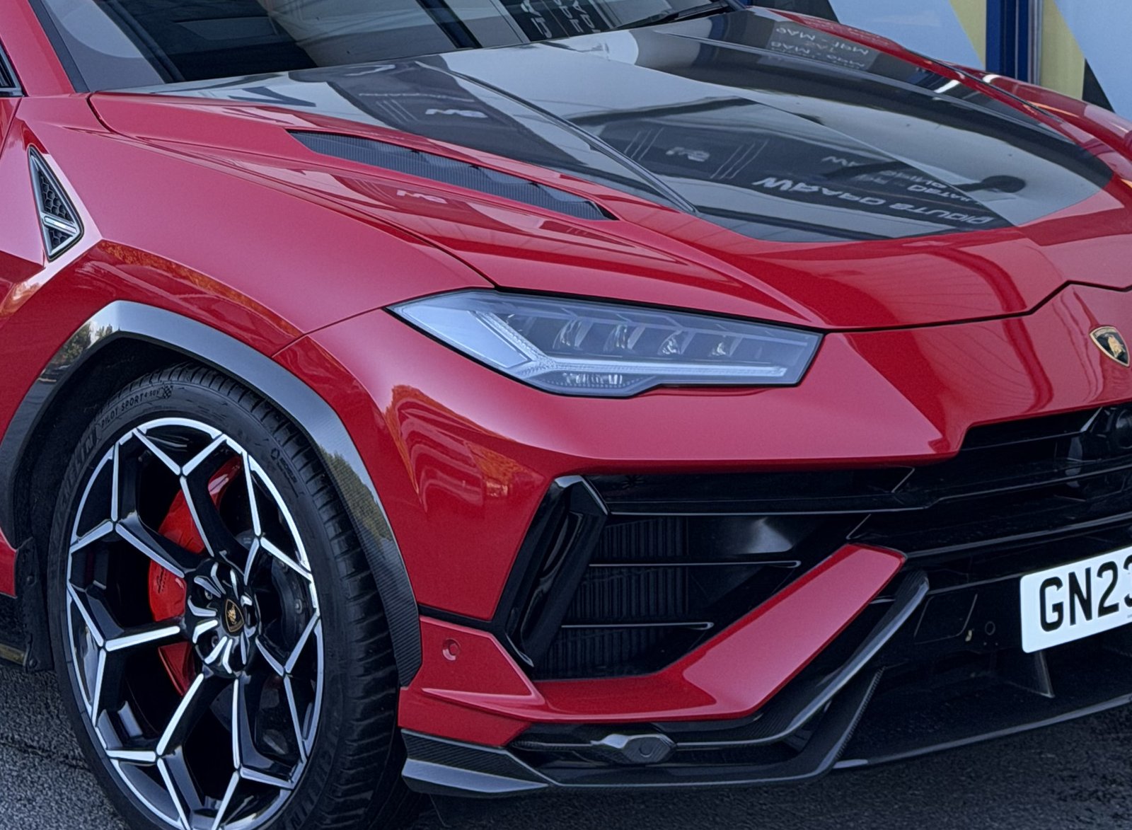 Red painted brake caliper behind the wheel of a Lamborghini Urus