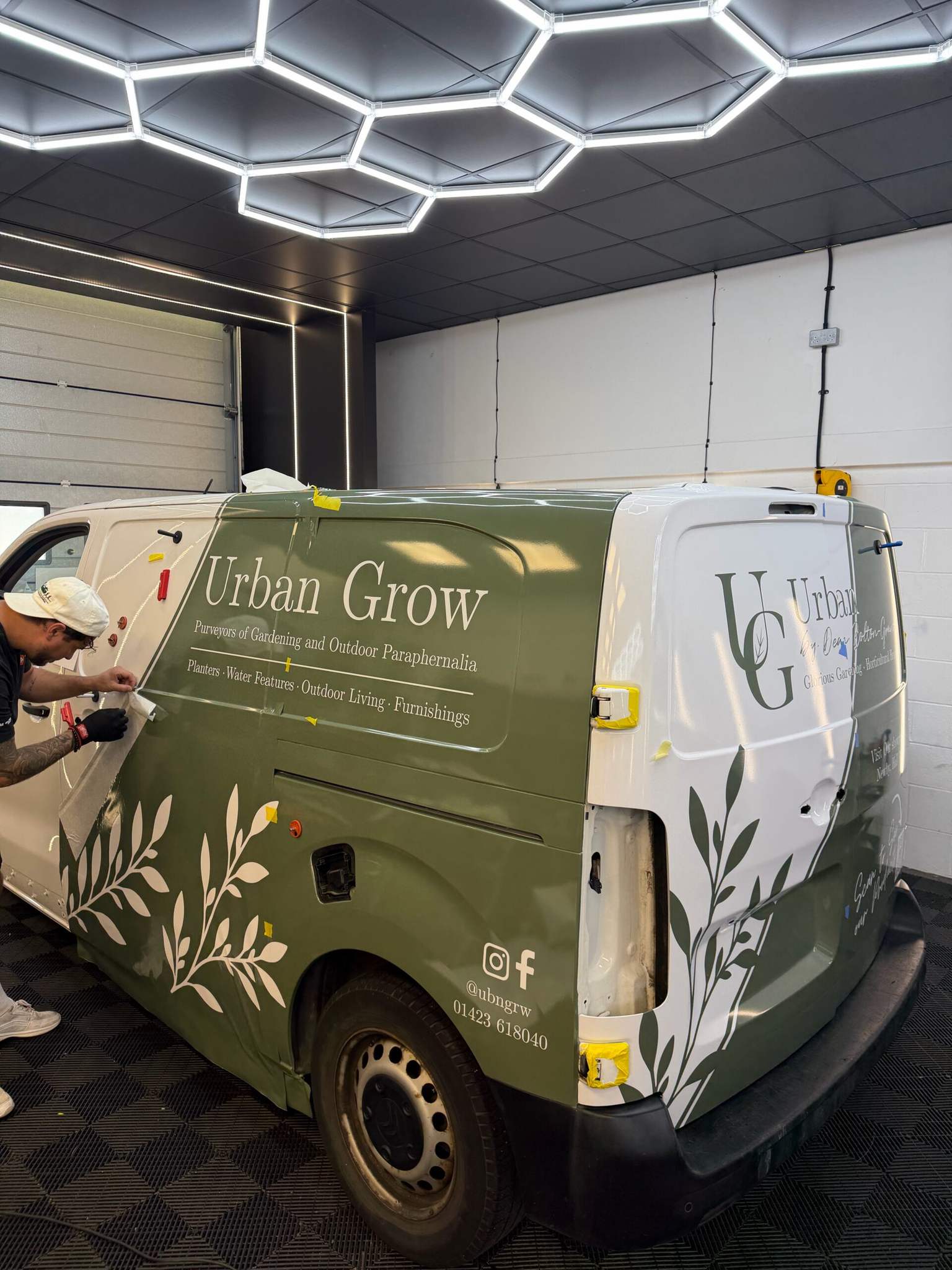 Fitter applying Urban Grow printed van livery at Wrapd Studios, Knaresborough